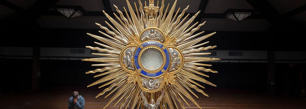 A gold and blue monstrance with the Eucharist in the center
